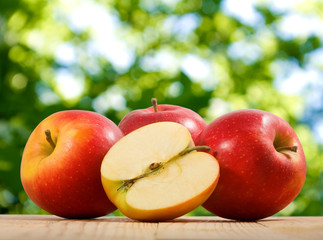 ripe apples on green background closeup