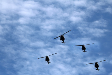 black helicopter aircraft during the flight with blue sky