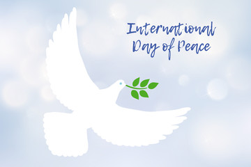 White dove carrying leaf branch and international day of peace. World Water Day. Vector image on blue blurred defocused background with bokeh ligth.
