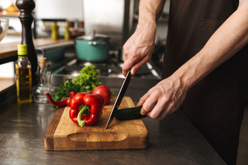 Obraz na płótnie Canvas Close up of a man hands chopping vegetables