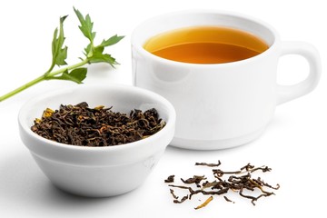 Cup of Green Tea with Dried Leaves Tea in Bowl