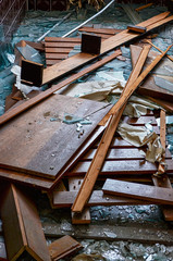 Shattered glass and pieces of wood on the floor in an abandoned building