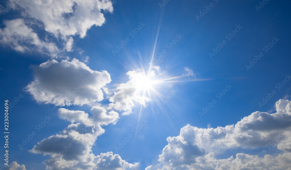 Wall mural blue sky with clouds and sun reflection.the sun shines bright in the daytime in summer