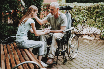 Old Man on Wheelchair with Girl. Aged with Girl.