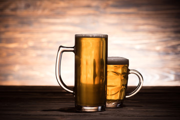 beer in two glasses on wooden table, oktoberfest concept