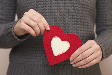 Woman holding a heart shaped coaster