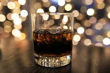 glass of cold alcohol drink with ice on table