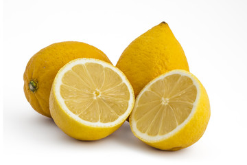 Composition of fresh ripe lemons, delicious citrus fruit isolated on white background. One cutted in half