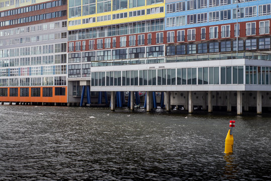 View on the Amsterdam residential area from the Amstel river in a cloudy day