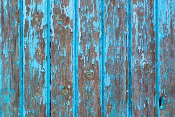 Fototapeta na wymiar A very sharp photograph of wooden boards previously painted in blue and very much affected by weather and time