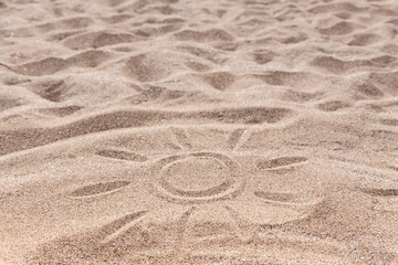 Fototapeta na wymiar Photo of a sandy beach with a drawn sun