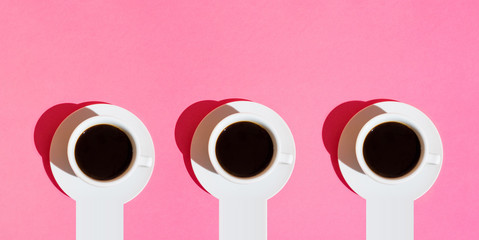 Long banner for cafes bars. White Cups of Coffee with Saucer on Neon Fuchsia Pink Color Background. Top View. Morning Breakfast Energy Caffeine Addiction Concept. Trendy Minimalist. Hard Sunlight. 80s