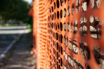 Construction safety fence, orange net around building site