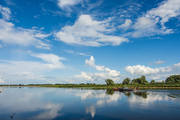 The Oka river in summer Sunny day and the river floats boat