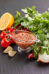 Traditional mexican red spicy sauce salsa with ingredients
