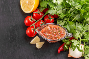 Traditional mexican red spicy sauce salsa with ingredients