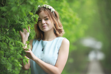 Girl in blue dress in green park