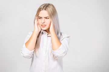 Portrait of beautiful young woman with bare shoulders touching her temples feeling stress, on white background