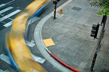  Multiple exposure of a taxi cab turning a downtown street corner as seen from above. © Kirk