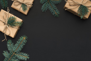 Fir branches and gift boxes on dark background