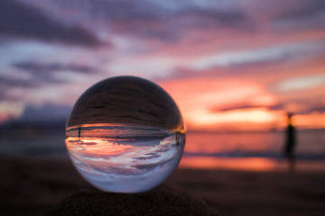 Bright Pink and Purple Seascape Sunset over Ocean with Glass Ball