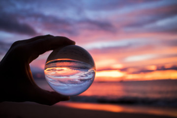 Bright Colorful Sunset over Ocean Captured in Glass Ball