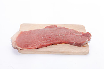 close up of raw beef top side on wooden board