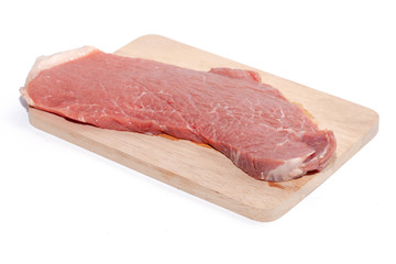 close up of raw beef top side on wooden board