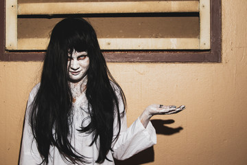 Concept of horror and holloween, women monster in white dress close up.