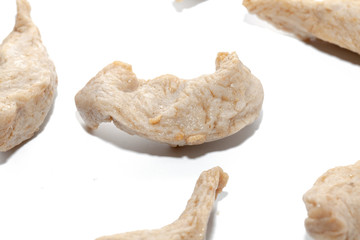 close up of raw fish ball on white background