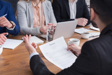 Commission interviewing young male job seeker on office