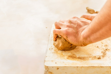 Man working with clay in a studio
