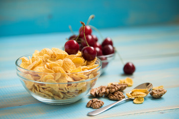 Tasty cornflakes with walnut in glass bowl