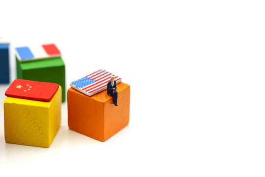 Miniature people : Businessman with international flag using for concept of United Nations Day.