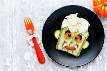Vampire sandwich for Halloween, healthy breakfast idea for children, vegetable sandwich shaped cute...
