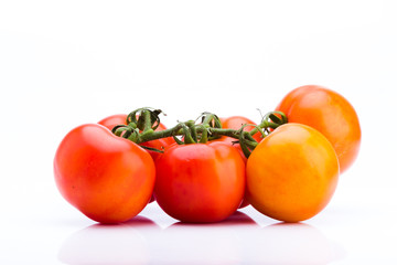 Cluster of fresh tomatoes on a white background, Ideal vegetable for a balanced diet
