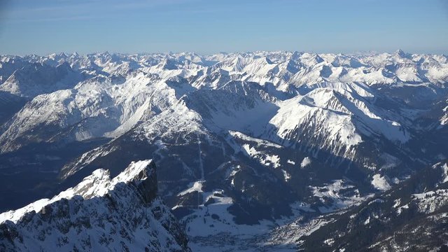 The alpine panorama seen from the summit of Germany's tallest mountain, the Zugspitze, looking west including the Hochvogel and Santis mountains, shot on a beautiful winter's day.