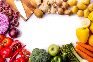 Top view of frame full of colorful fresh vegetables on a white background