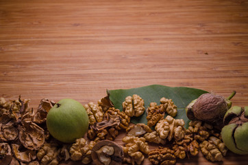 Walnuts Seeds with Leaves on Wooden Texture