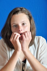 Scared teen on blue background