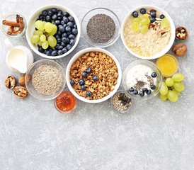 Breakfast food table. Plant based breakfast or brunch set, meal variety with  overnight oats, granola , fresh berries and various of topping. Overhead view, copy space