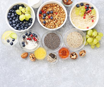 Breakfast food table. Plant based breakfast or brunch set, meal variety with  overnight oats, granola , fresh berries and various of topping. Overhead view, copy space