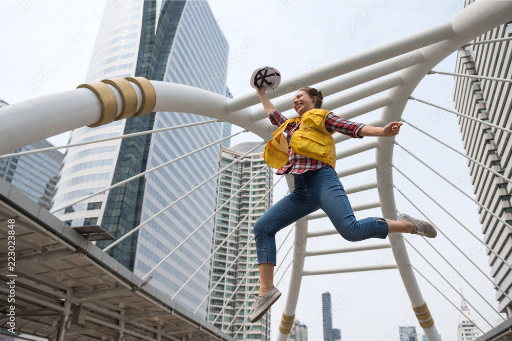 Wall mural Happy American engineer jump in city