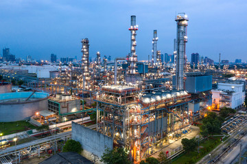 Industrial view at oil refinery plant form industry zone with sunrise and cloudy sky.Oil refinery and Petrochemical plant at dusk,Thailand. Aerial view