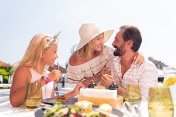 Great news. Joyful happy woman smiling while looking at her husband