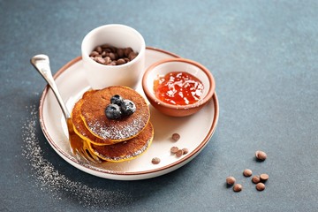 Obraz na płótnie Canvas Pumpkin pancakes with chocolate chips and fresh blueberry. 