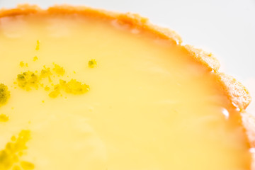 One single lemon tart, isolated on white.