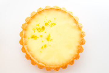 One single lemon tart, isolated on white.