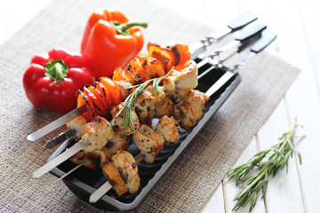 Kebab cooked on metal skewers with vegetables