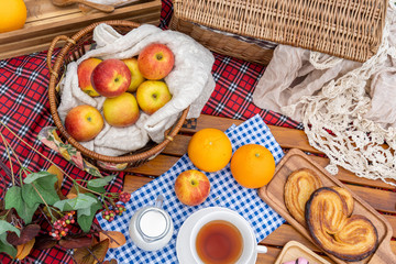 Picnic items setting in a park, have many fruit and bekery